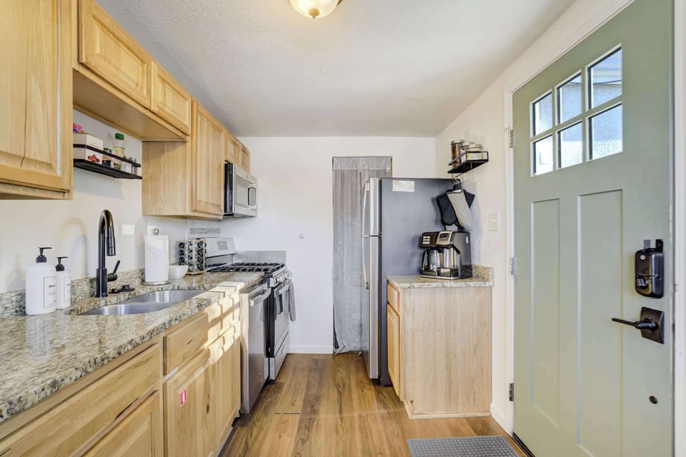 Our kitchen includes labeled cabinets to help you find exactly what you need for everyday cooking. This area also provides easy access to your private entrance and the shared backyard oasis just outside.