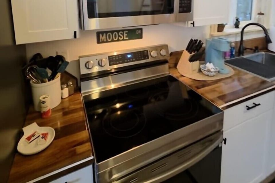 Kitchen includes an electric range, refrigerator, and Keurig.