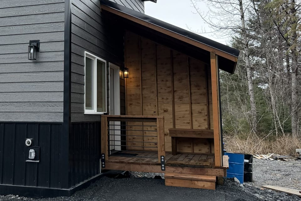 Cabin entrance with covered porch area.  There will be a freezer on the porch.