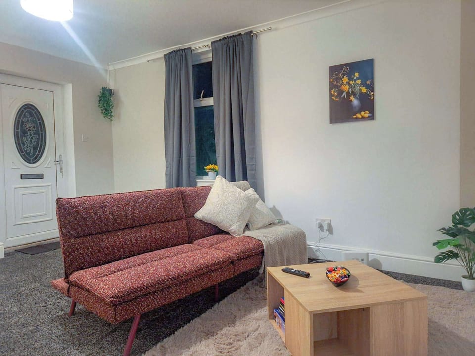Lounge area offering a cosy space to relax, with comfortable seating and a warm, homely atmosphere.