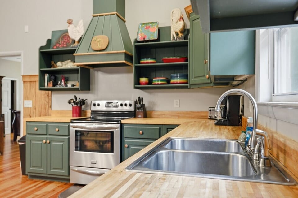 Kitchen | Butcher Block Countertops | Stainless Steel Range & Open Shelving