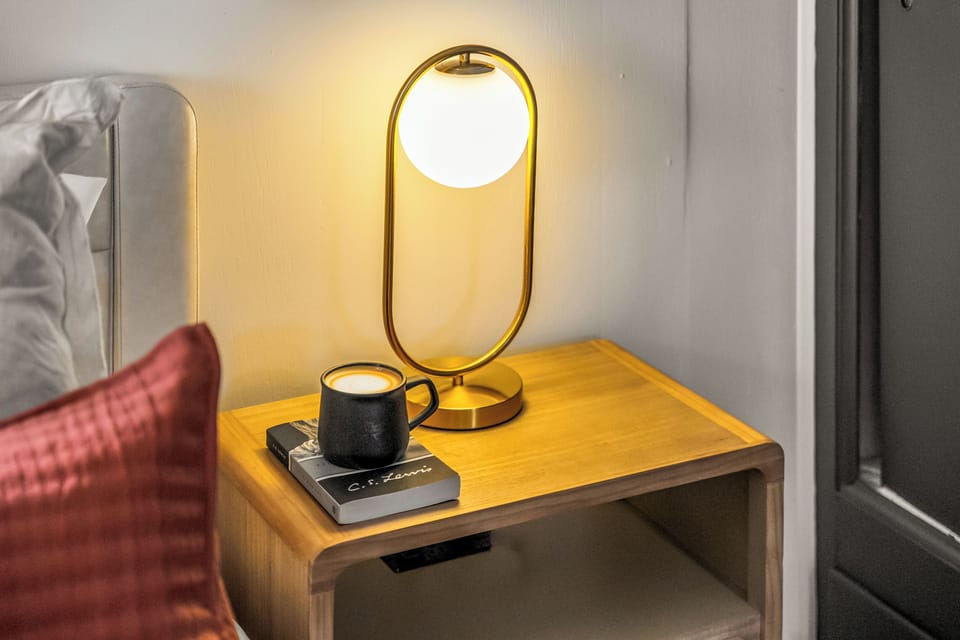 Sip your morning coffee in this stylish king bed with warm, earthy tones before 