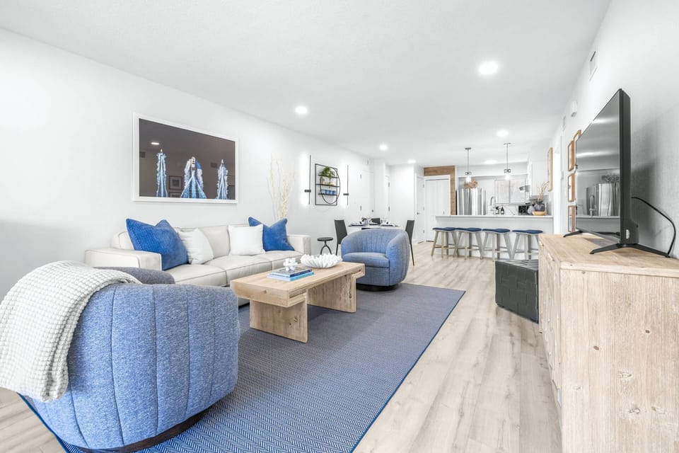 Spacious open-concept living area with comfortable seating and a bright, airy layout.