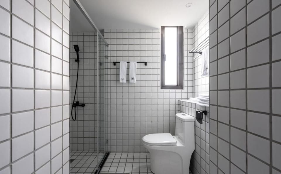 Deluxe Double Room, Balcony, City View | Bathroom | Hair dryer, slippers, towels, soap