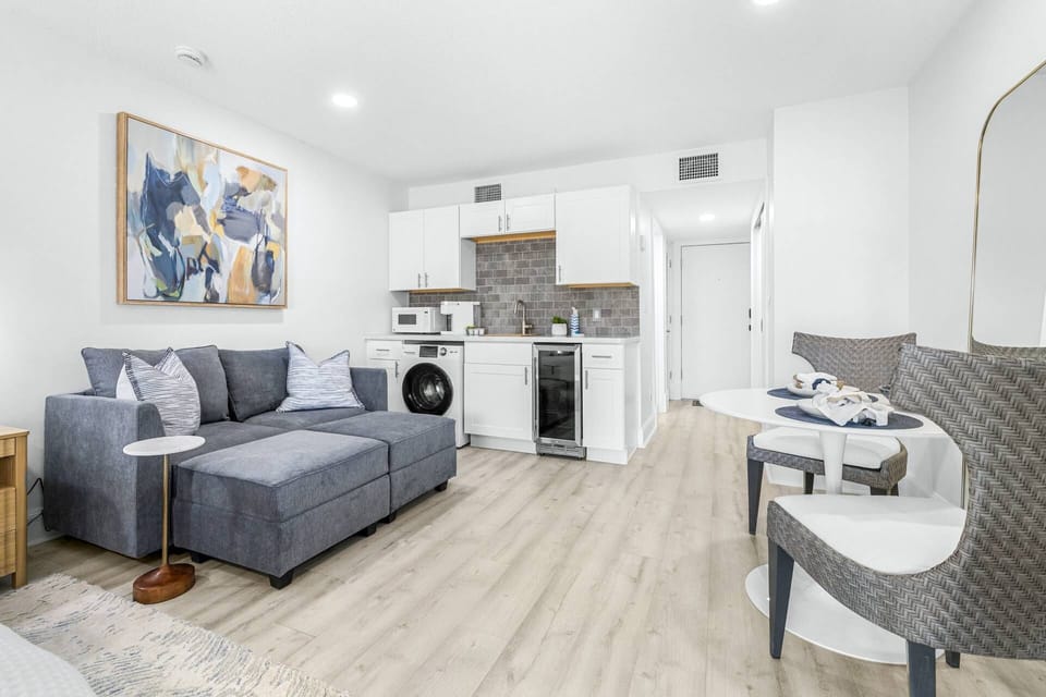 Open-concept lounge with sleek furnishings and a plush couch for ultimate comfort.