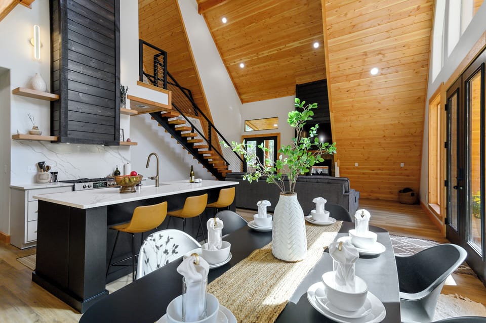 Bright dining and kitchen space with modern finishes and natural wood accents