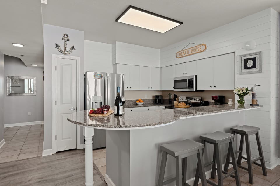Modern kitchen featuring granite countertops and stainless steel appliances.