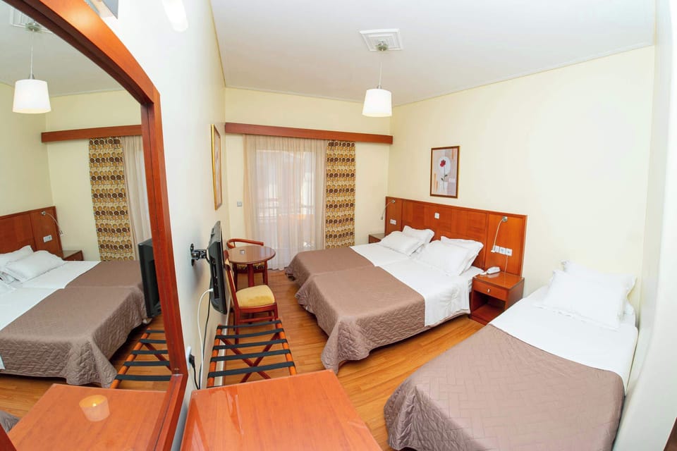 A bright and airy triple suite with 3 single beds and space to relax after exploring the area. Convenient for visiting nearby sights!