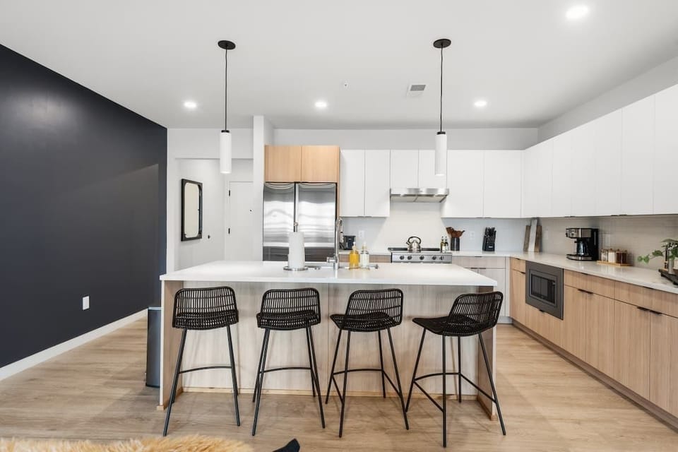 Modern chef’s kitchen with sleek white cabinetry and high-end appliances.