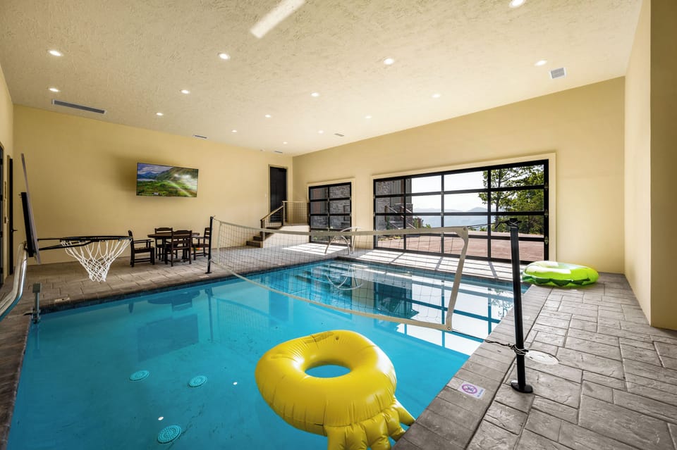 16 x 20 ft heated salt water pool with basketball, volleyball, seating and smart TV.