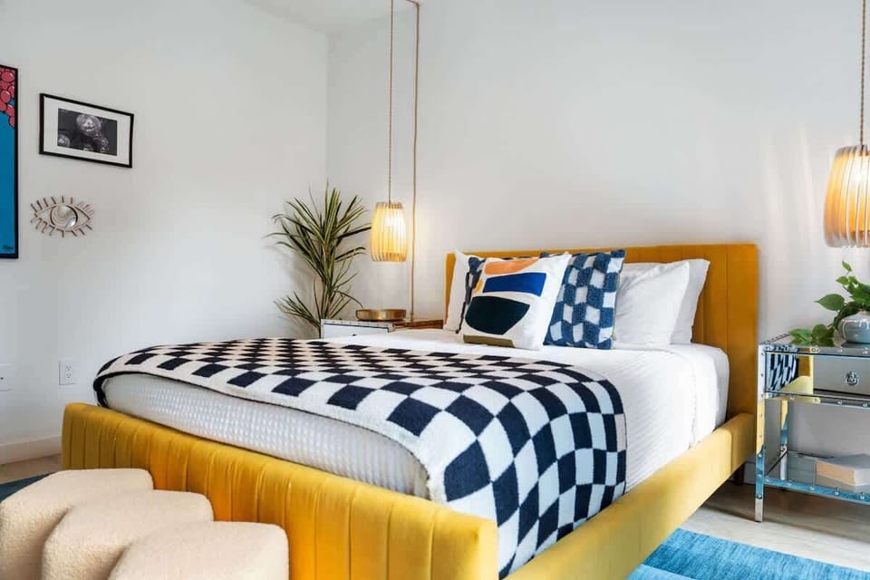 Queen bedroom with hanging lamps and side tables