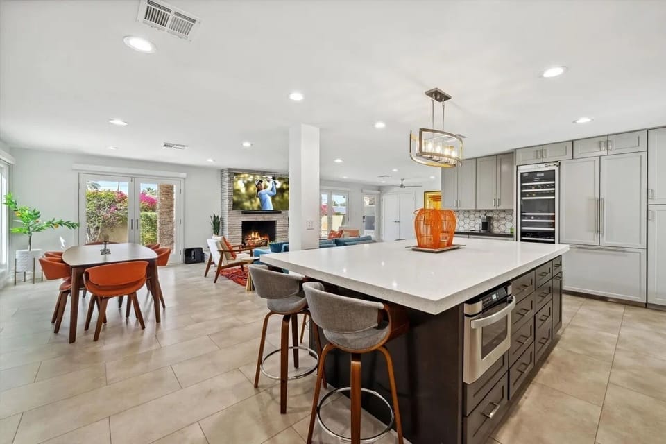 Kitchen with high end appliances, wine fridge and island.