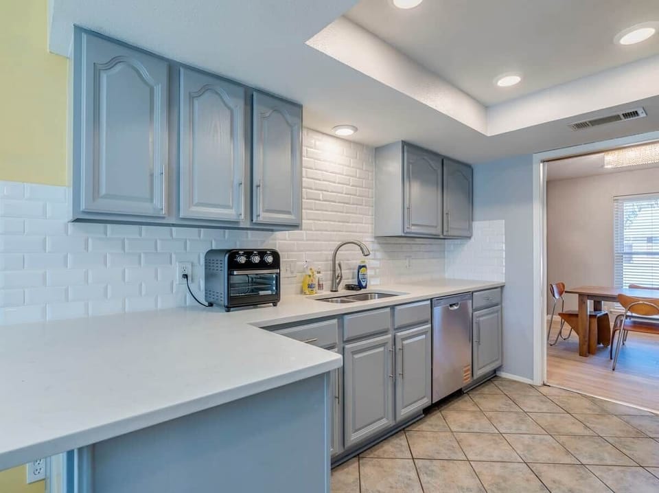 Kitchen has Dishwasher, Microwave, Refrigerator, Electric Stove, Oven, Dishware, Filter Coffee Maker. 
