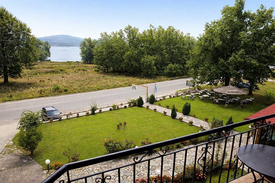 Private balcony with open views of the lake and greenery.