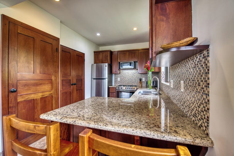 Fully outfitted kitchen.  The laundry machines are behind the wooden doors.