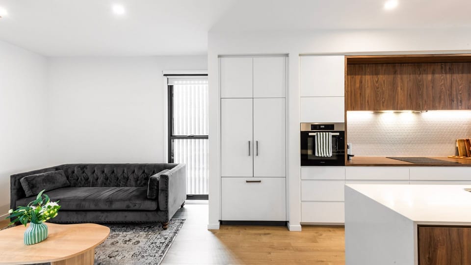 Open-plan living & kitchen with designer finishes and cozy seating.