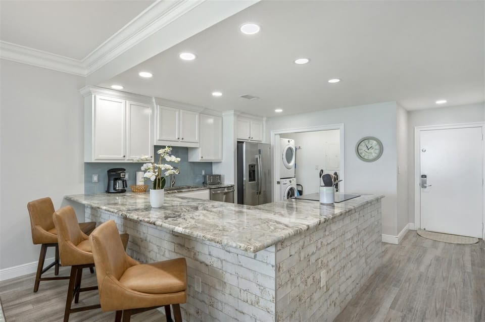Your gourmet kitchen features marble countertops, premium appliances, and a spacious island perfect for morning coffee and meal prep.