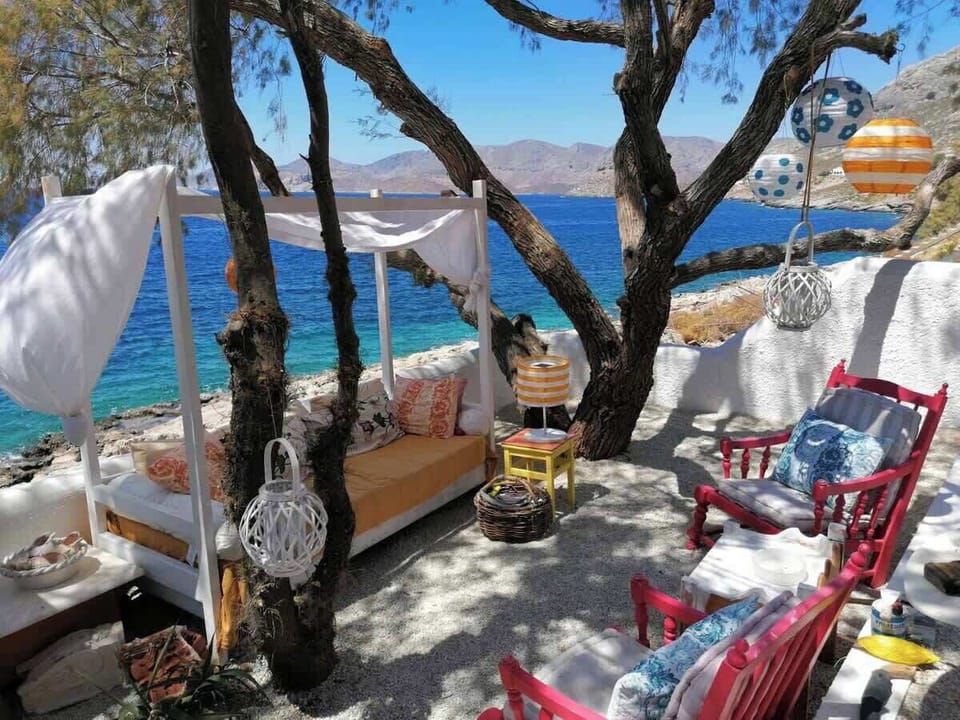 Private Mediterranean Beach Terrace with Shaded Daybed and Coastal Seating