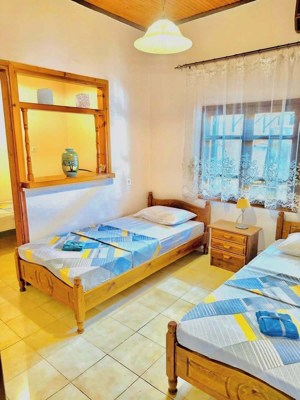 2nd bright bedroom with natural light and three cozy single beds, ideal for families or friends.