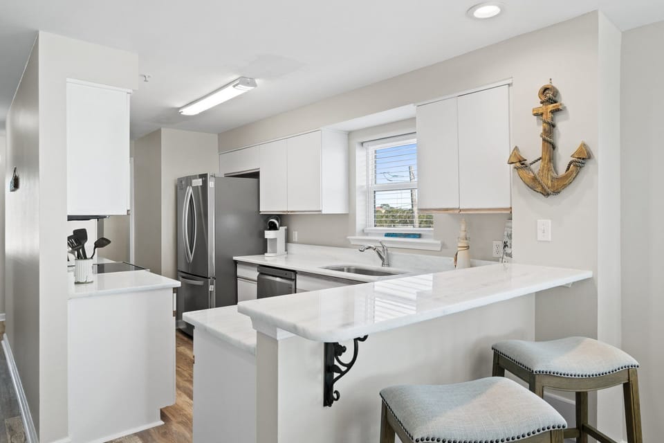 Modern kitchen with sleek countertops and appliances for your convenience