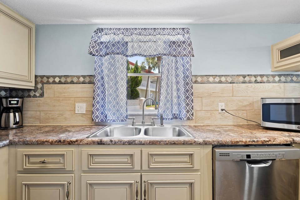 Convenient kitchen area with all the appliances you need for a home-cooked meal