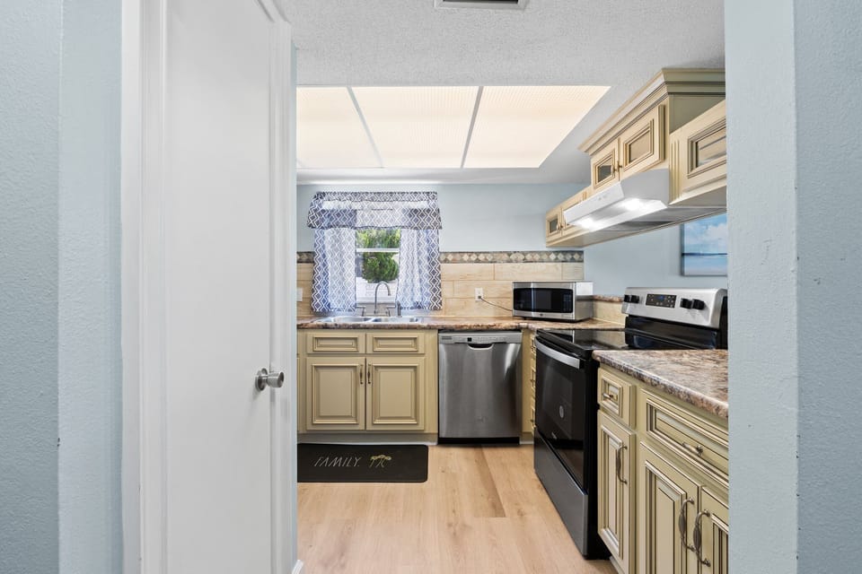 Convenient kitchen area with all the appliances you need for a home-cooked meal