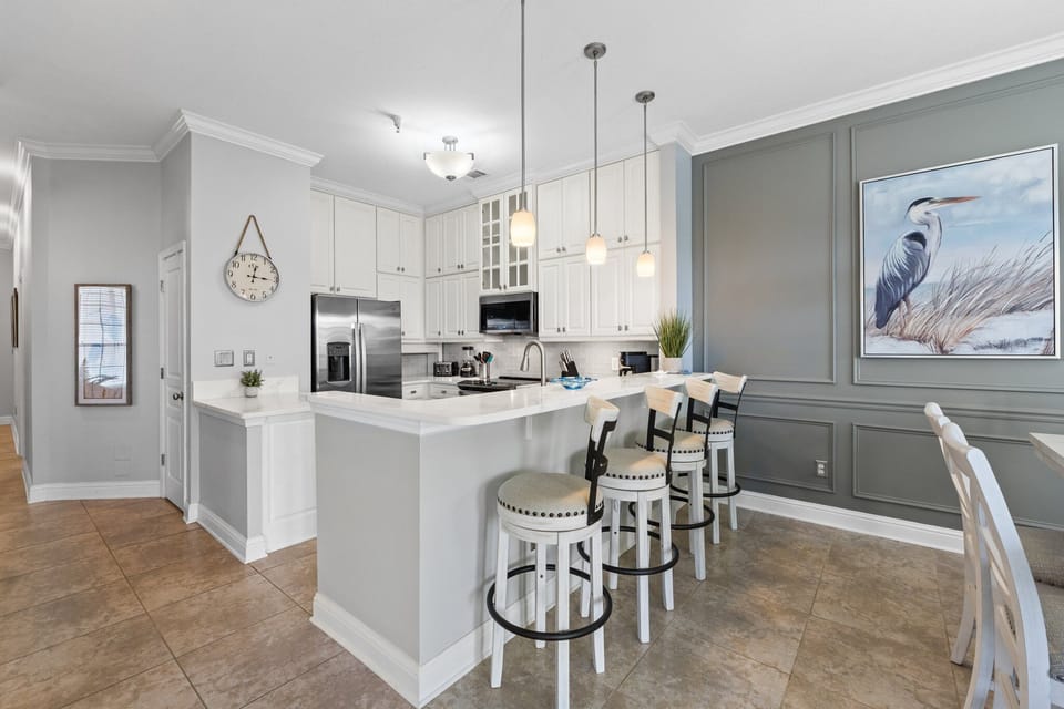 The inviting bar seating offers the perfect spot for quick bites, morning coffee, or evening drinks with friends.