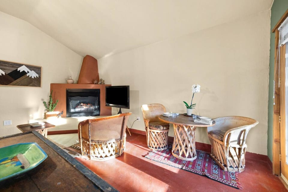 Casita living space with sleeper sofa, TV, dining space, and gas fireplace