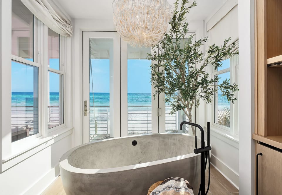 Soak in luxury with ocean views from your private spa-like bathroom, where waves meet modern elegance.