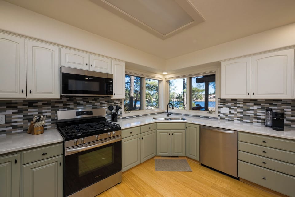 Your fully equipped kitchen features modern appliances and stunning water views, perfect for preparing meals while enjoying lakefront scenery.