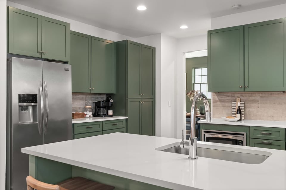 Fully equipped kitchen with stainless steel appliances, gas range, and plenty of cabinet storage.
