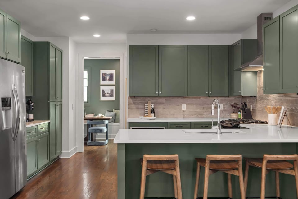 Spacious kitchen with large peninsula and bar seating — ideal for morning coffee or late-night snacks.