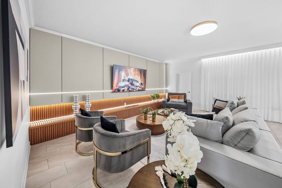 Relax in this stylish living area, featuring a plush sectional sofa and contemporary accent chairs. The warm wooden accents and soft lighting create a cozy atmosphere, perfect for unwinding after a day of adventure.