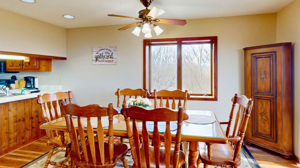 Gather around this inviting dining space where warm wood tones and natural light create the perfect setting for your memorable meals together.