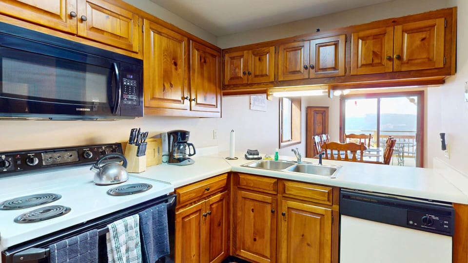 Your fully equipped kitchen with warm wood cabinetry and mountain views makes preparing meals a joy.