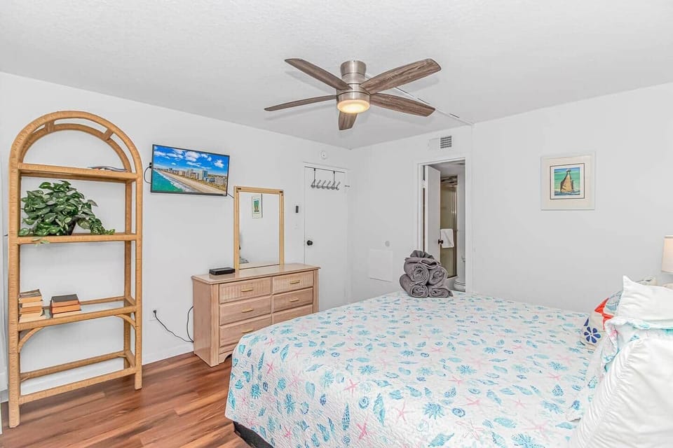 Relax in this airy king bedroom with coastal décor, plenty of storage, and easy access to the updated bathroom.