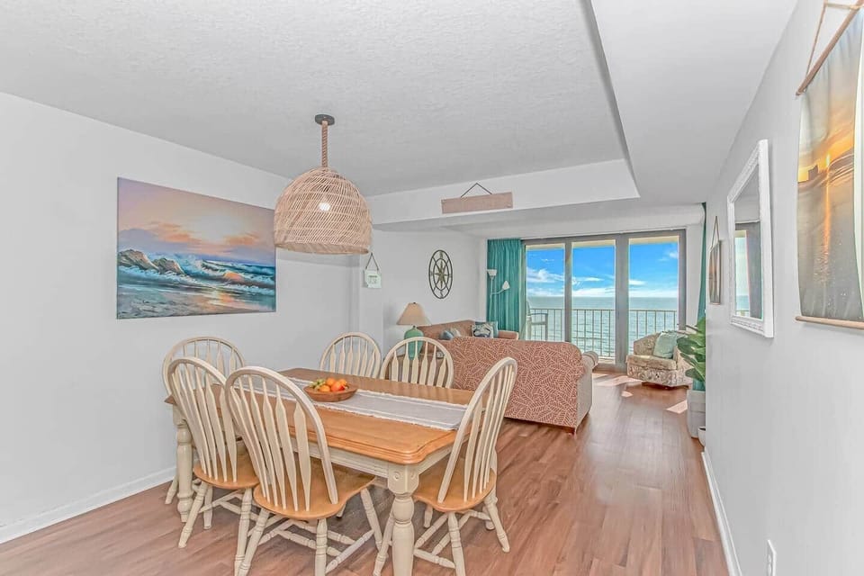 Bright dining area that opens into the cozy oceanfront living room — perfect for meals with a view.