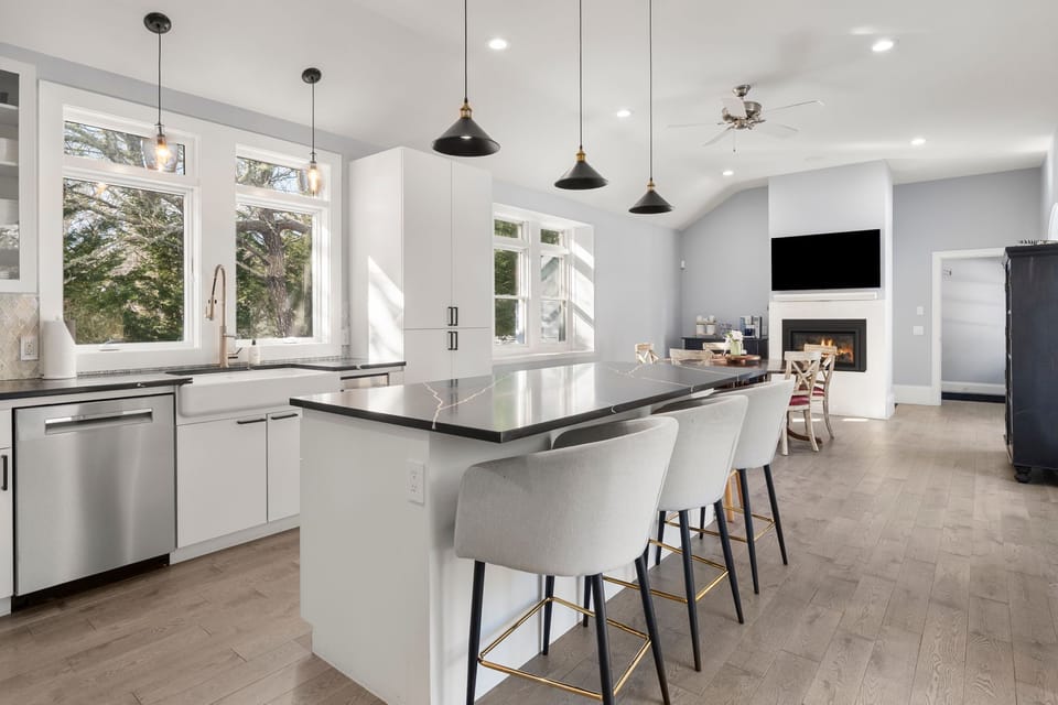 Full kitchen, island for 5, table for 4, TV, coffee bar & fireplace.