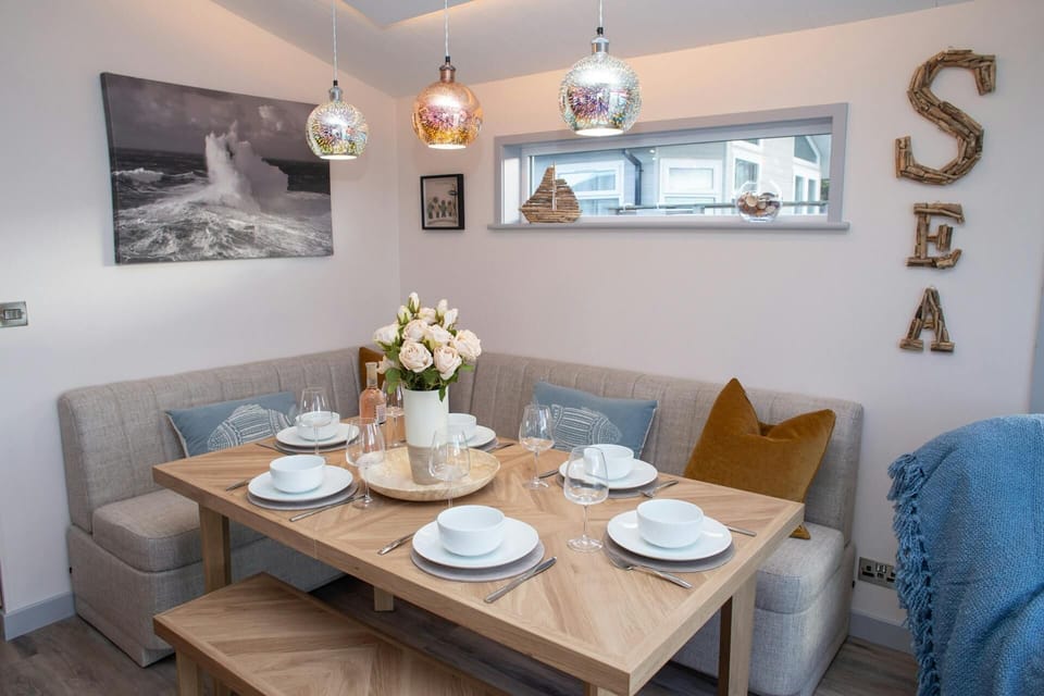 Corner dining nook with upholstered bench seating and wooden table set for six