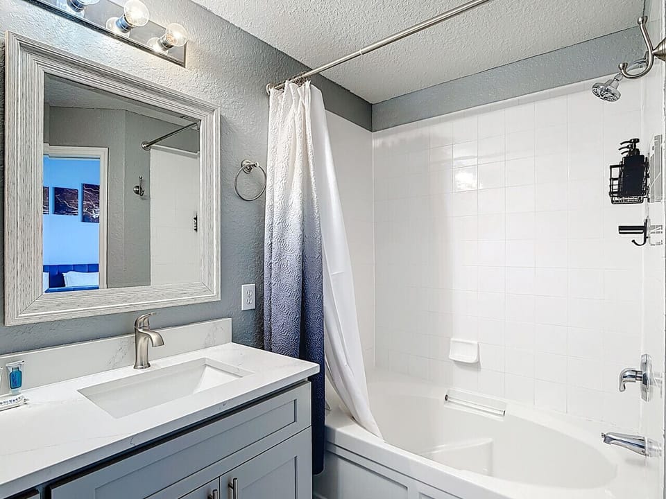 Clean bathroom with tub and shower combo