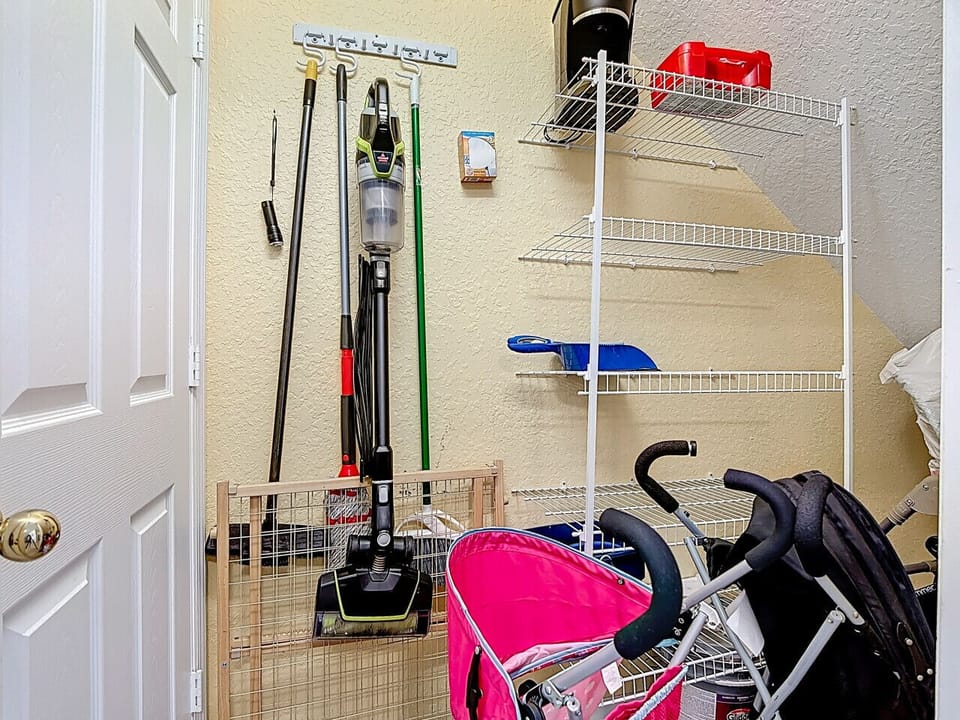 Utility closet with cleaning supplies for guest use