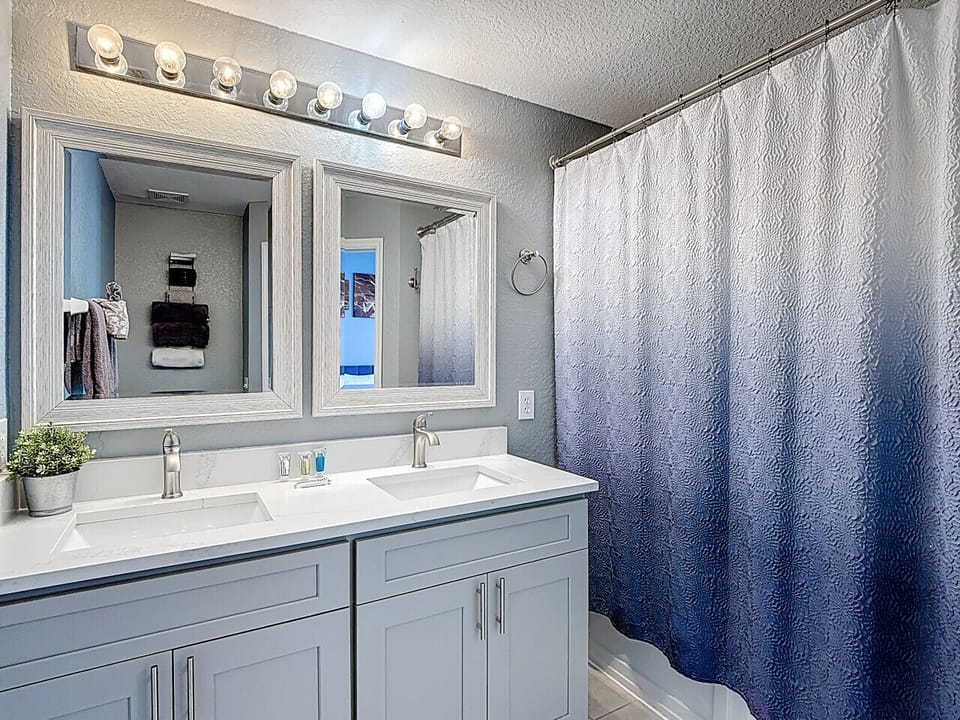 Bathroom with double vanity and large mirror