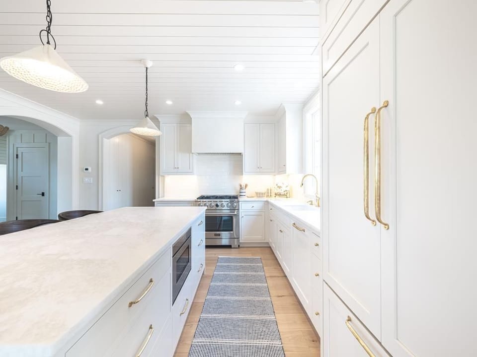 Another angle of the contemporary kitchen showcasing sleek design elements and ample counter space for preparing meals.