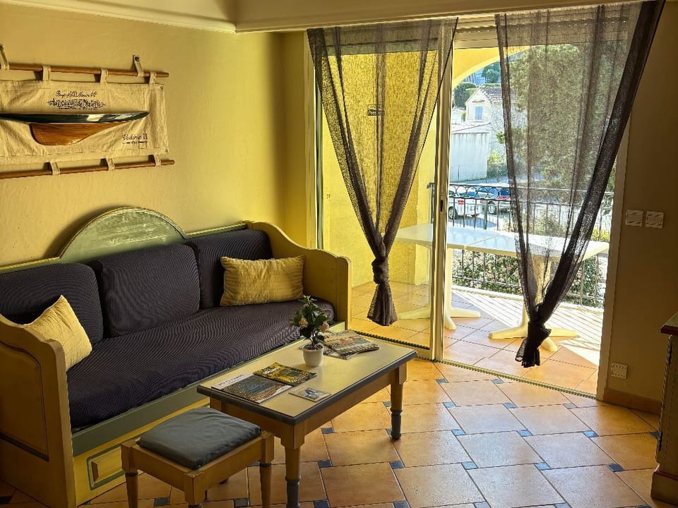 Bright and cozy living area with comfortable seating and direct access to a private balcony.