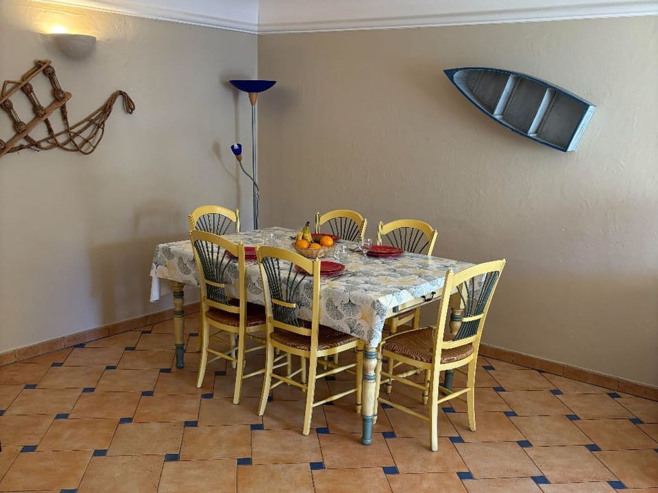 Charming dining space with tiled floors and a nautical touch, perfect for family meals.