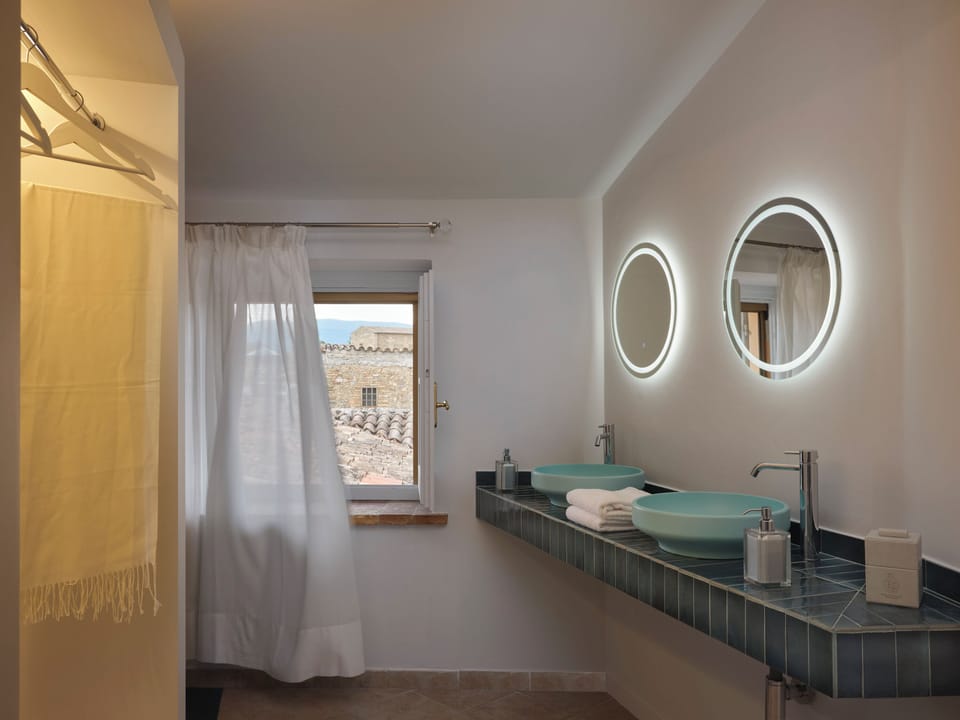 Romantic Suite, City View | Bathroom | Shower, hair dryer, slippers, soap