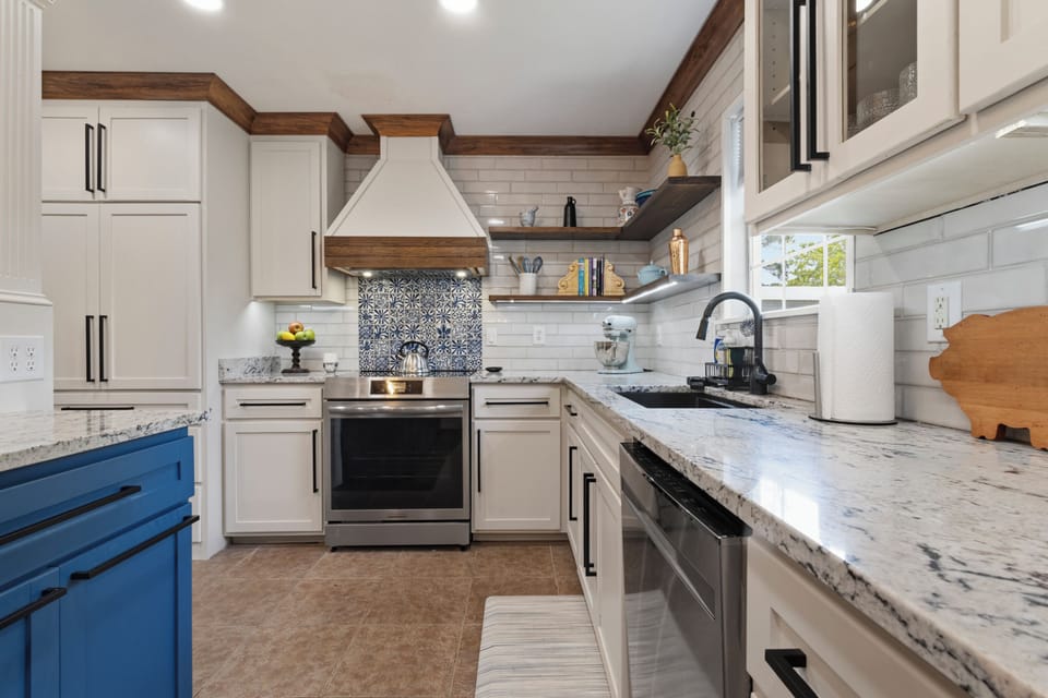 Stunning custom-made woodwork and granite countertops throughout kitchen