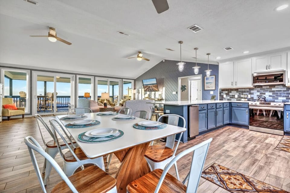 This gorgeous open-concept kitchen and dining area flows seamlessly into a living room with stunning ocean views.