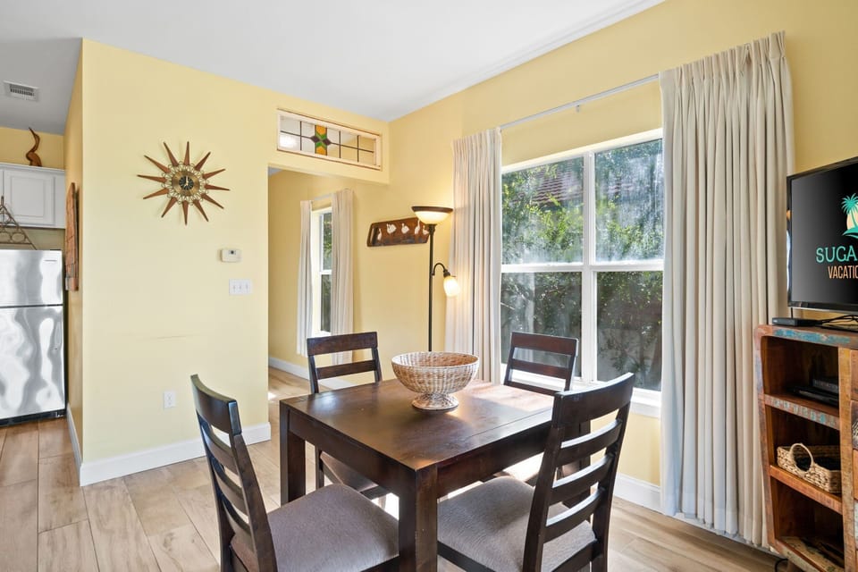 Open dining area flows into living and kitchen with stunning Gulf backdrop.
