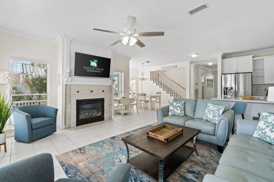 Cozy up in this bright and inviting living room with a fireplace, perfect for relaxation.